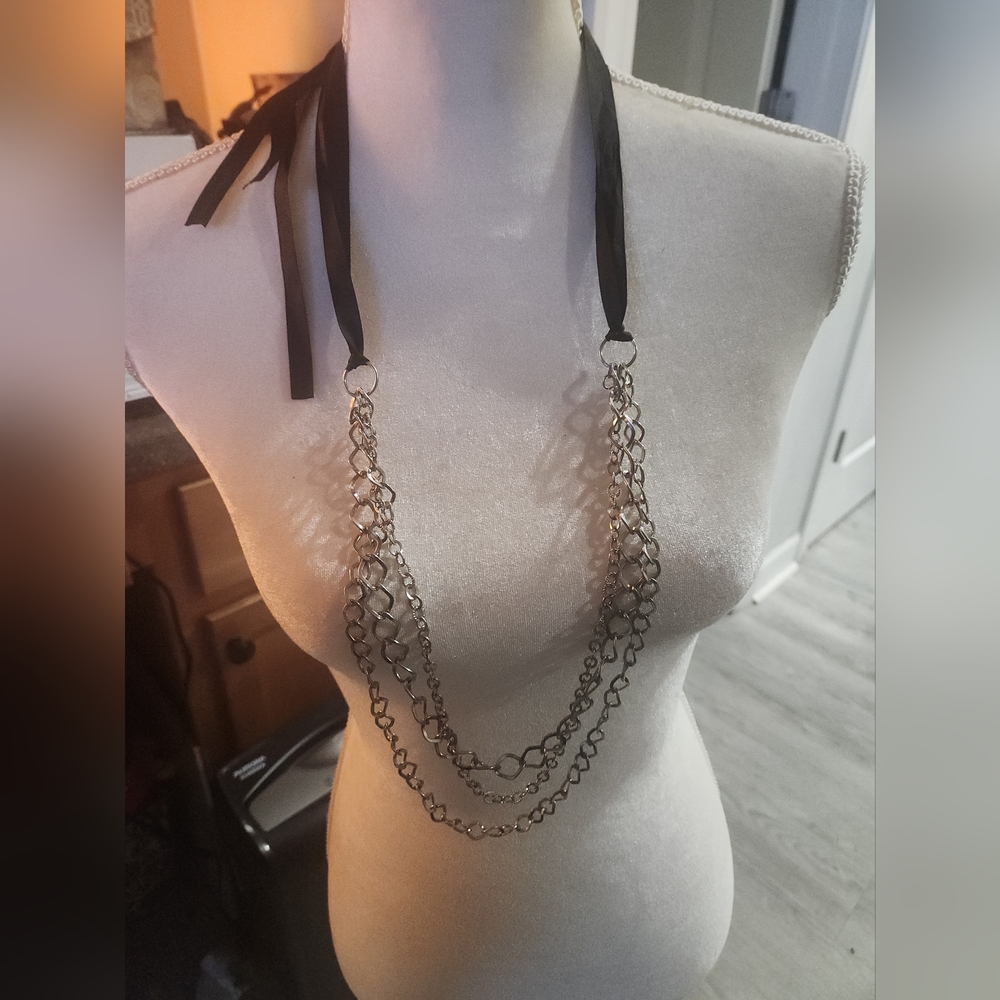 Necklace with silver chains and black ribbon ties